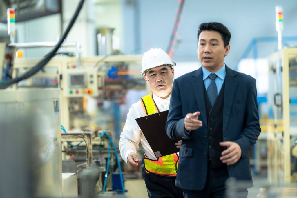engineers and factory supervisors inspecting a production line