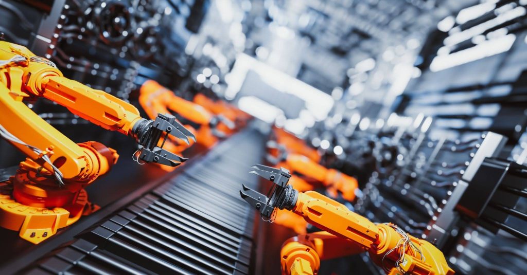 robotic arms along assembly line in modern factory.
